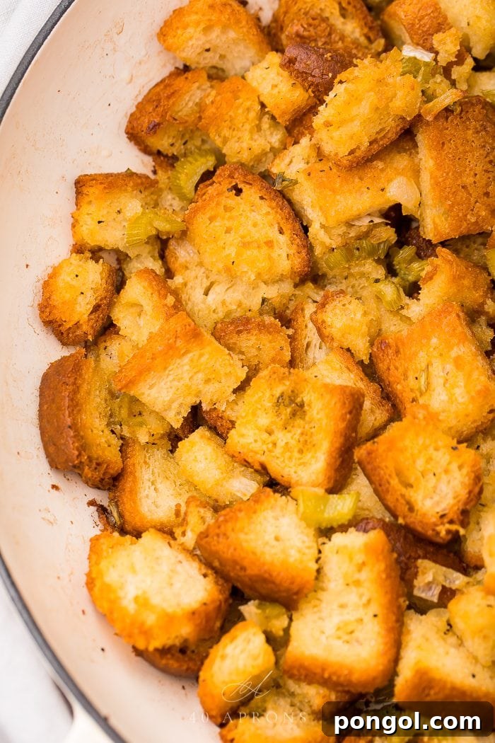 A serving of golden gluten-free stuffing on a crisp white plate, ready for a holiday meal