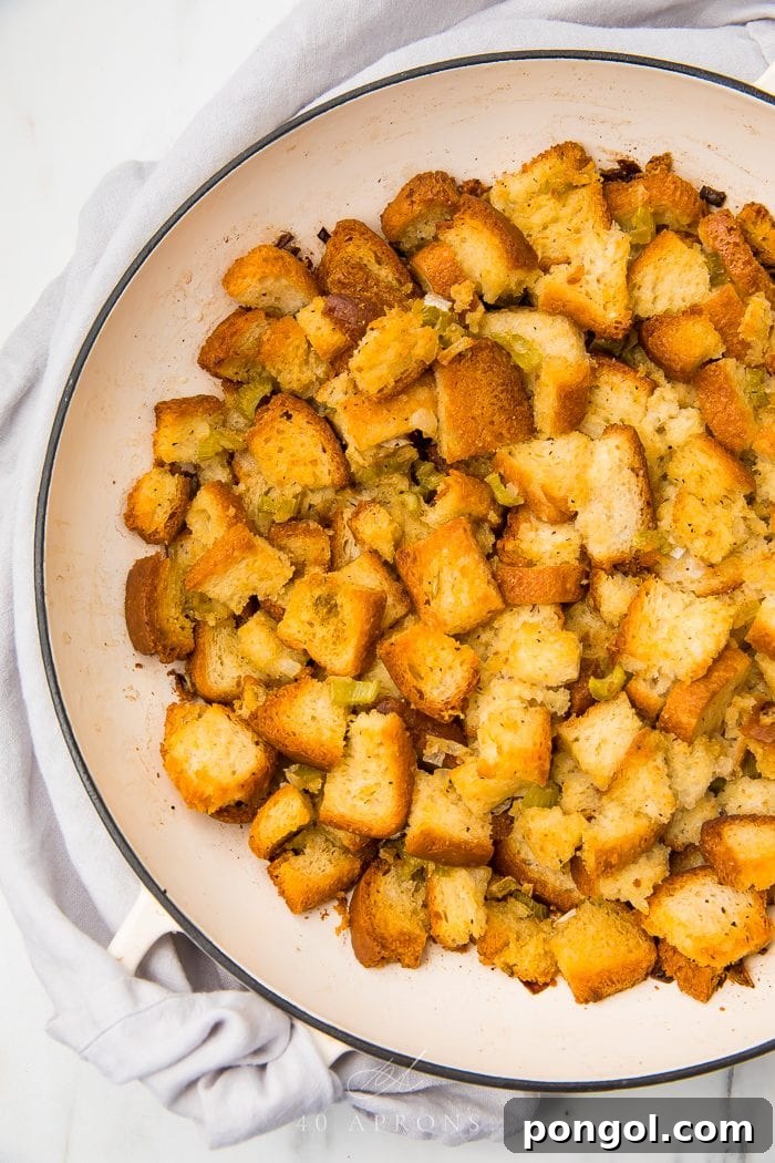 A rustic bowl filled with prepared gluten-free stuffing mixture, ready for baking or turkey stuffing