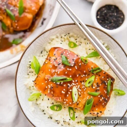 Teriyaki salmon served in a bowl with cauliflower rice and chopsticks