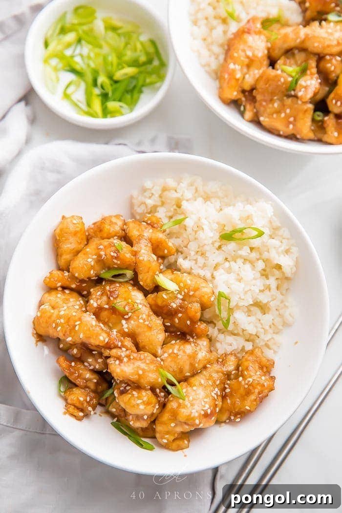 Wholesome Whole30 Sesame Chicken 2 Whole30 sesame chicken over cauliflower rice in a bowl