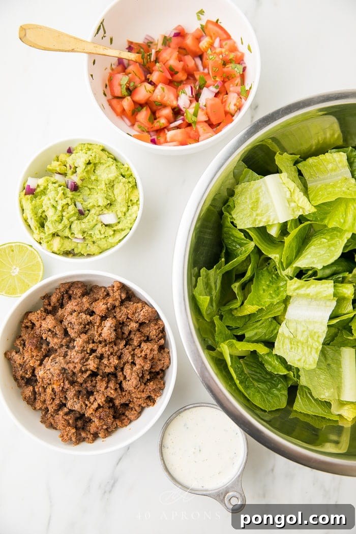 A selection of fresh ingredients laid out on a cutting board, ready for the healthy taco salad recipe.