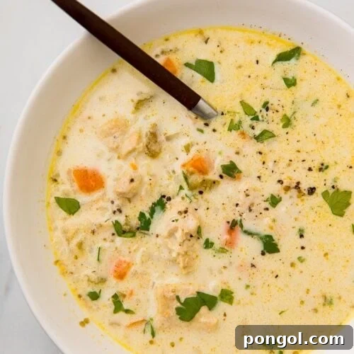 Chicken and cauliflower rice soup garnished with fresh herbs