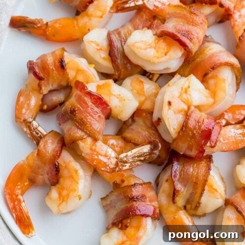 Bacon wrapped shrimp on a white plate