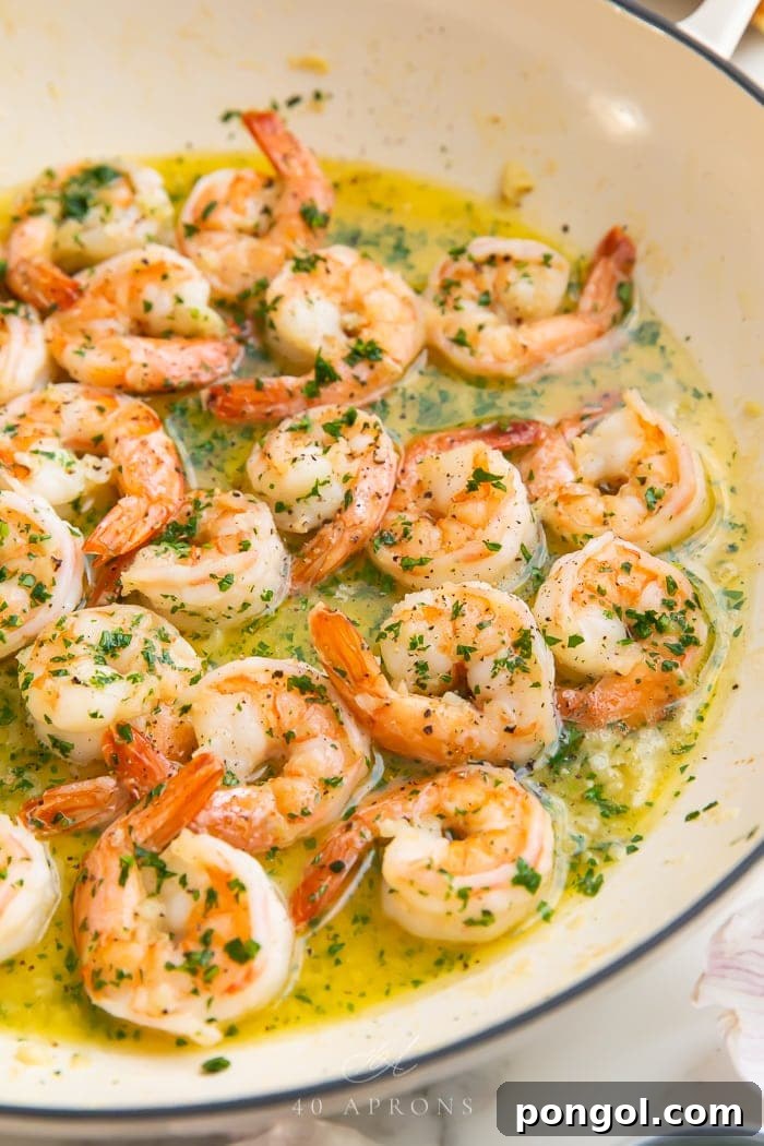 Savory Garlic Butter Shrimp 5 Close-up of garlic butter shrimp in a skillet, showcasing the golden color and rich sauce.