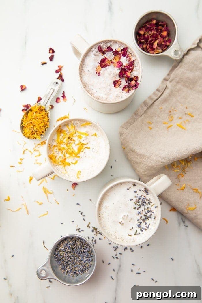 Three versions of moon milk in white mugs, representing traditional, tart cherry, and honey lavender flavors.