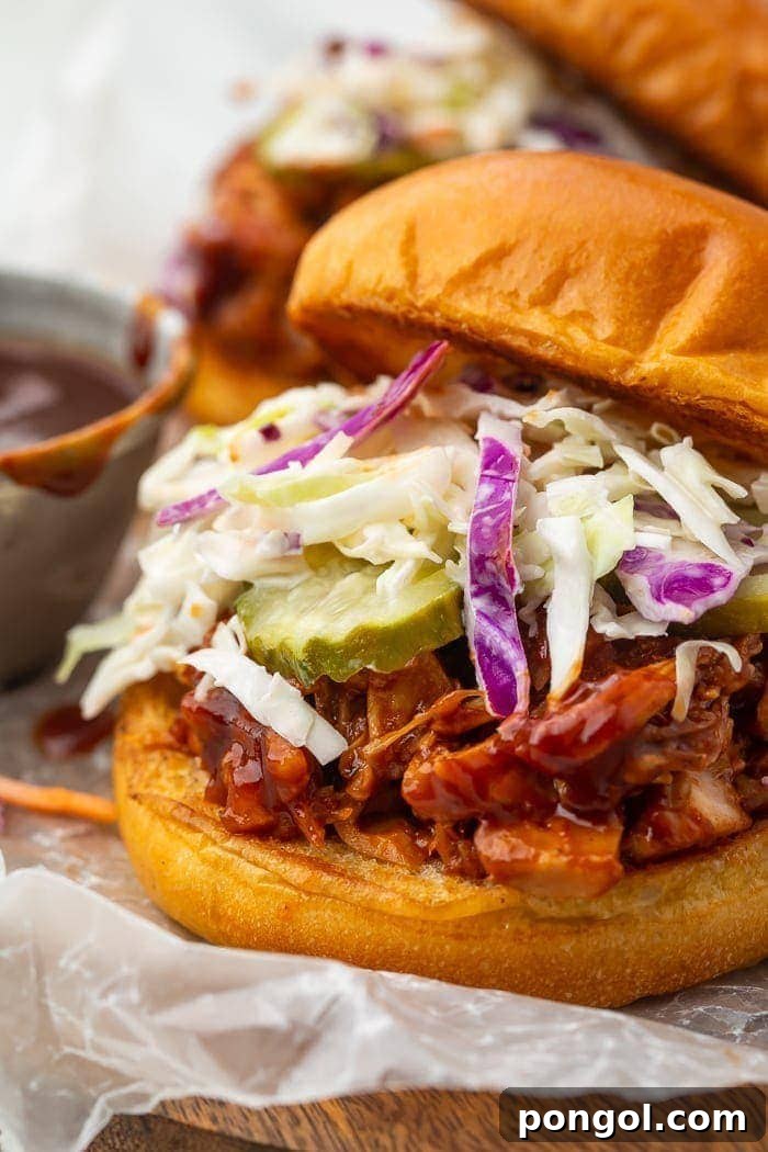 Smoky Pulled Jackfruit BBQ Sandwiches 2 BBQ jackfruit sandwich on brioche bun with coleslaw and pickles