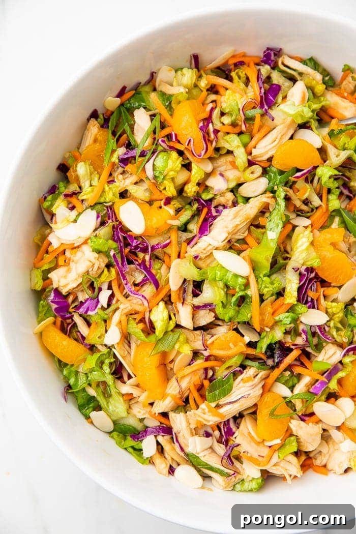 Overhead angle of part of a white bowl containing Chinese chicken salad