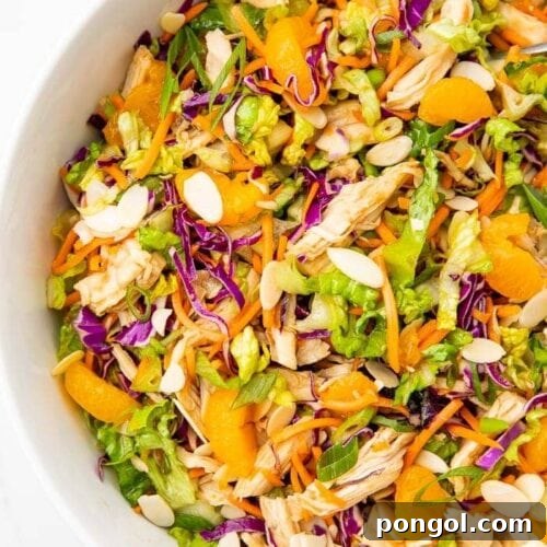 Overhead angle of part of a white bowl containing Chinese chicken salad