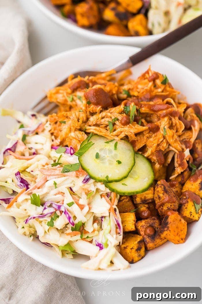 Flavorful Whole30 Dinner Ideas 4 A vibrant BBQ chicken bowl featuring shredded BBQ chicken, roasted sweet potatoes, and a fresh coleslaw.