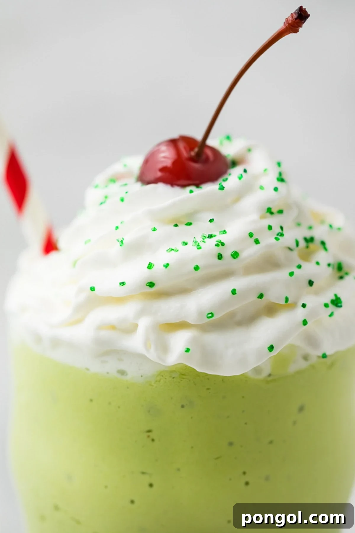 Emerald Vegan Mint Shake 4 An even closer view of a healthy dairy-free shamrock shake copycat, highlighting the creamy texture, white whipped cream, and juicy cherry.