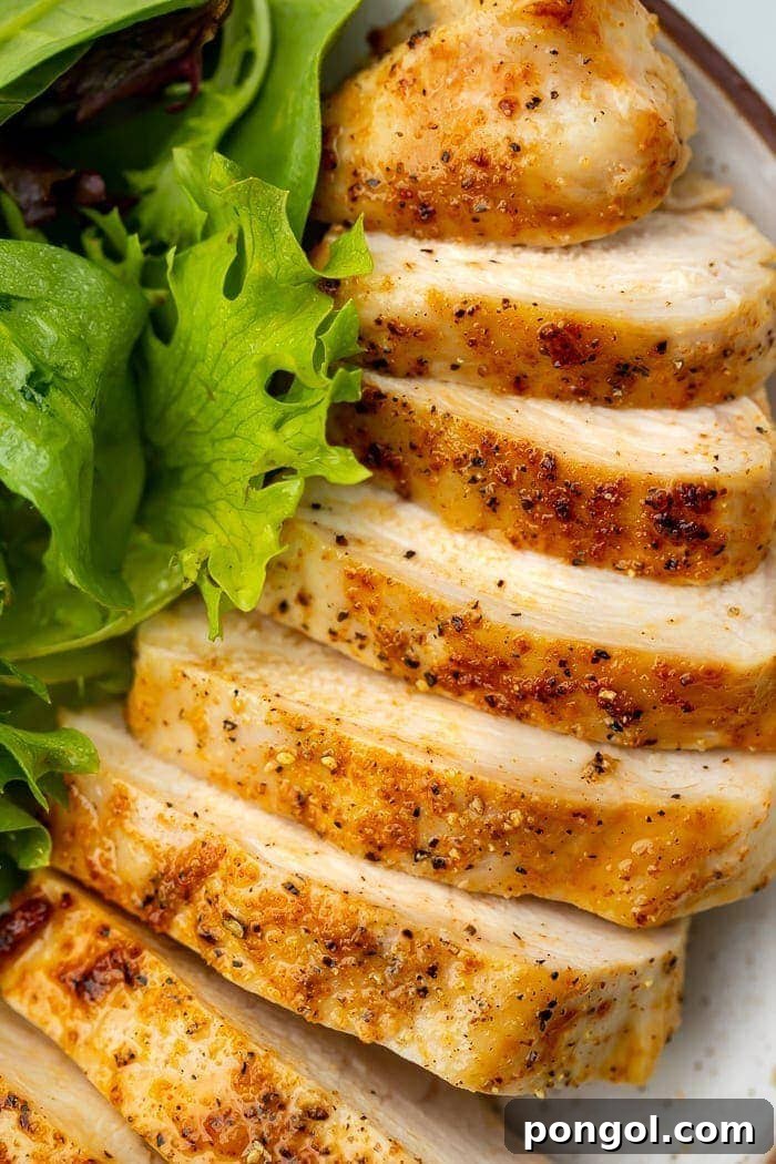 Close-up of perfectly cooked, golden-brown, and juicy air fryer chicken breast