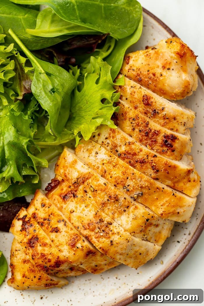 Perfectly sliced air fryer chicken breast, showcasing its incredibly juicy and tender interior