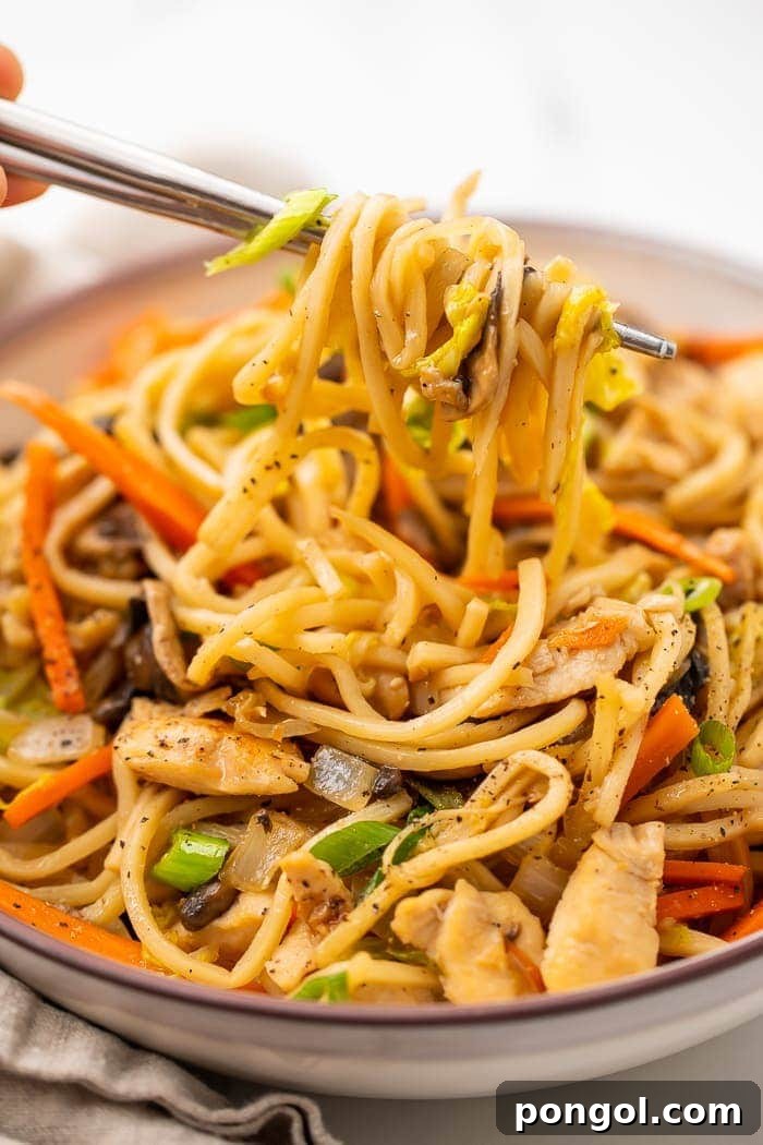 Whole30 chicken lo mein in a bowl with two chopsticks