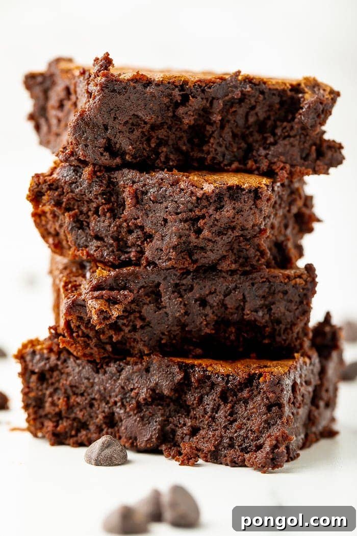 Stack of four delicious black bean brownies, showcasing their fudgy texture and rich color.
