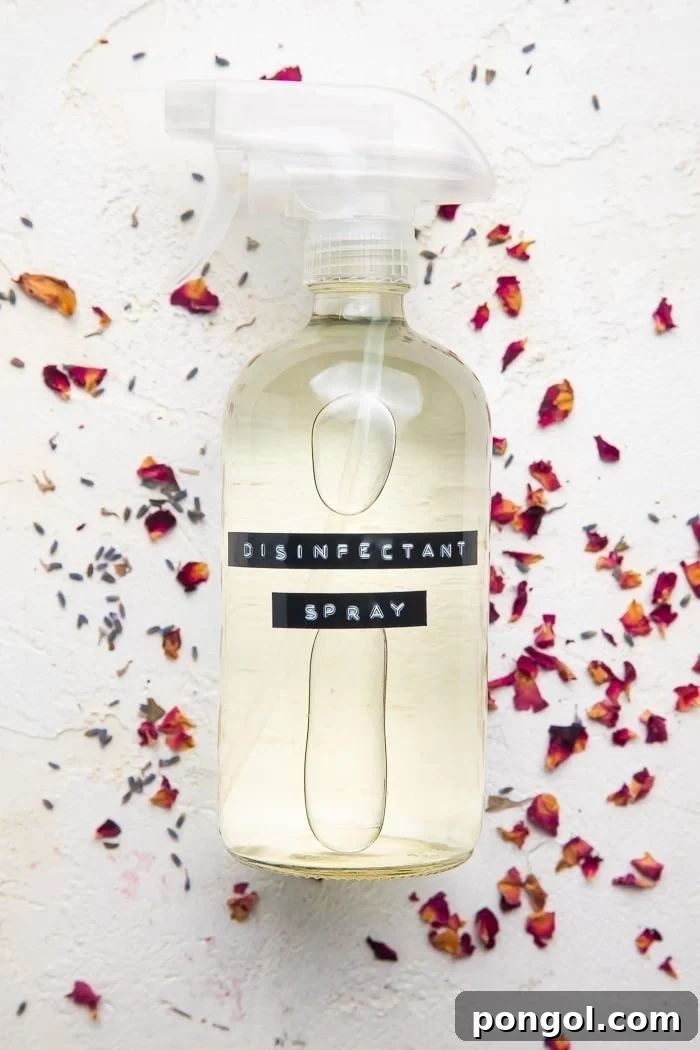 Spray bottle of DIY Lysol spray on dried rose petals
