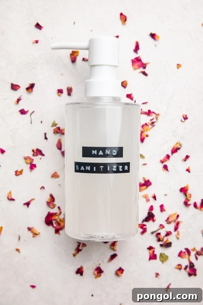 Easy Homemade Hand Sanitizer 2 A bottle of homemade hand sanitizer infused with essential oils, set against a backdrop of dried rose petals, emphasizing its natural and customizable essence.