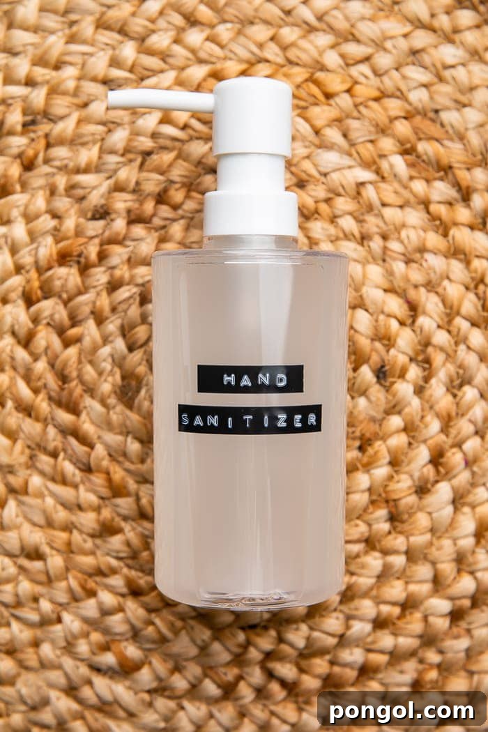 Easy Homemade Hand Sanitizer 5 A simple yet elegant bottle of homemade hand sanitizer resting on a woven mat, showcasing its functional and aesthetic appeal.