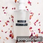 Homemade hand sanitizer recipe in bottle on dried rose petals