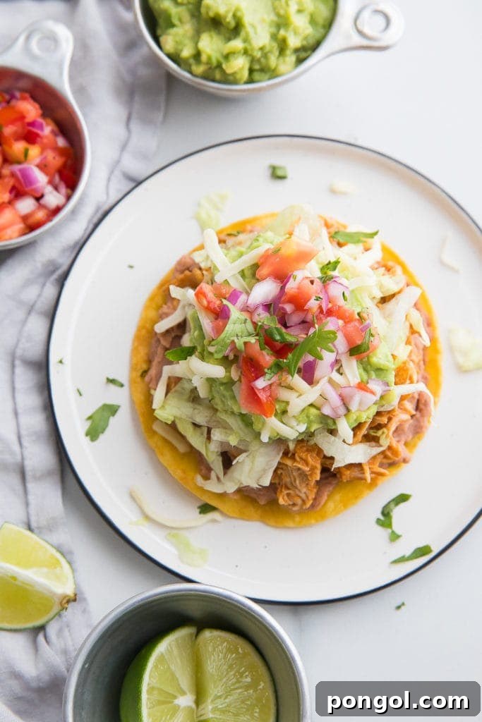 A plate of healthy baked chicken tostadas, vibrant with fresh toppings, showcasing flavorful chicken tinga and a crispy base, ideal for an easy weeknight meal.