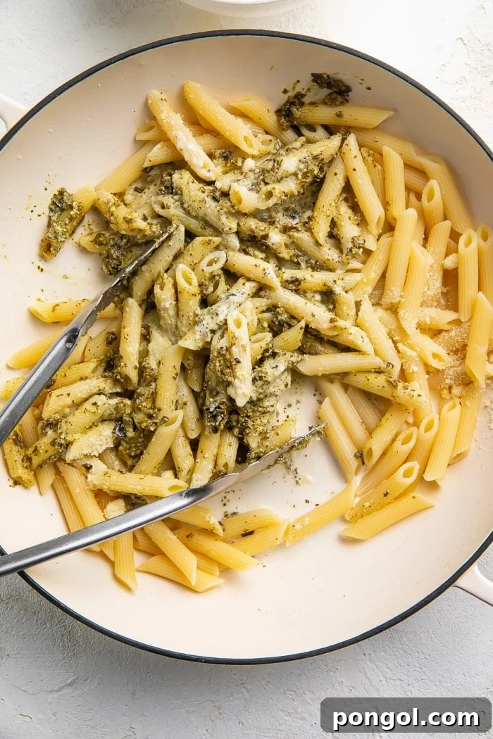 Chicken pesto pasta being stirred