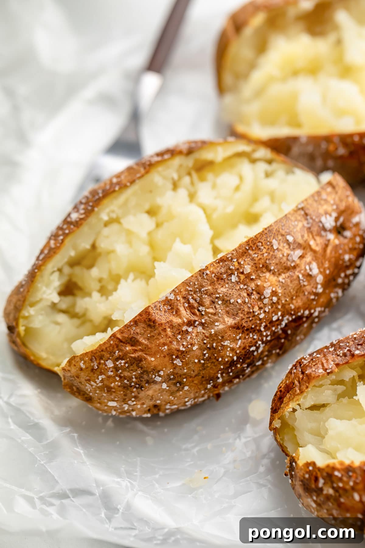 Air fryer baked potato, split down the center and fluffed.