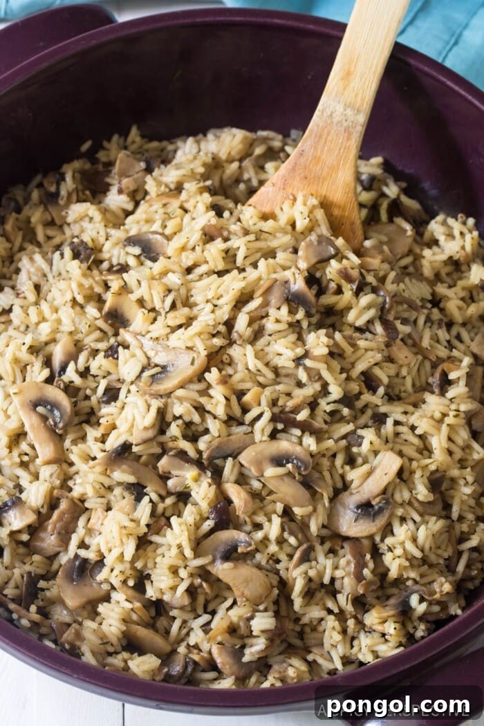 A savory mushroom rice pilaf, rich with earthy mushrooms and aromatic herbs, presented in a bowl ready to be enjoyed as a gourmet side.
