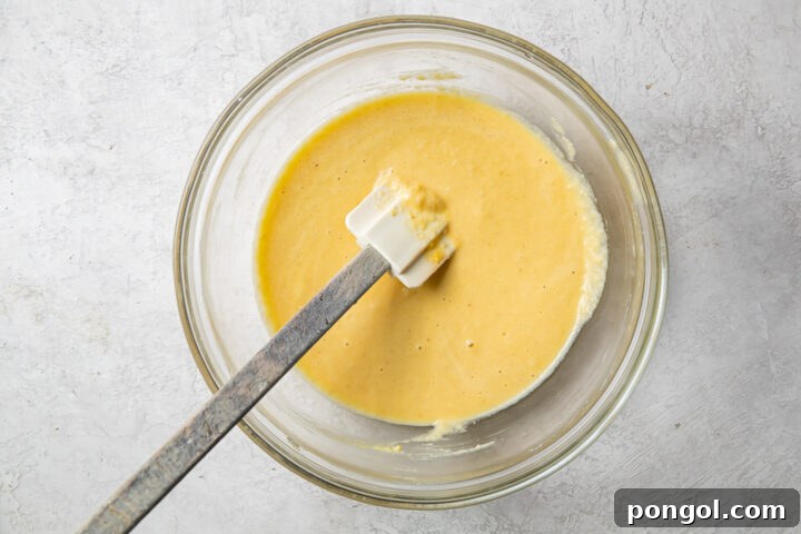 Thinner batter for paleo pancakes in a glass mixing bowl.