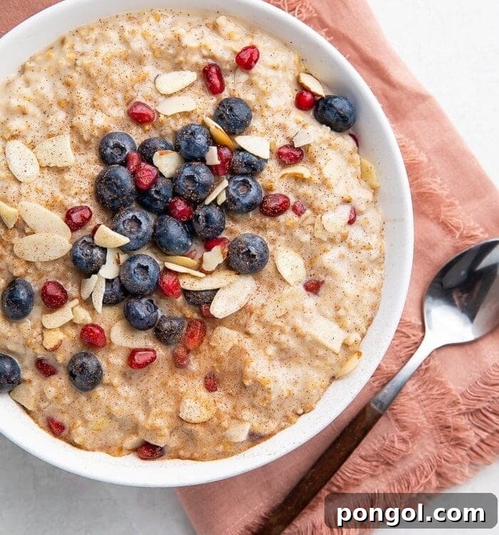 Creamy Overnight Steel Cut Oats 5 A cozy scene featuring a bowl of overnight steel cut oats, complete with a pink napkin and spoon, emphasizing the comfort and appeal of a well-prepared breakfast.