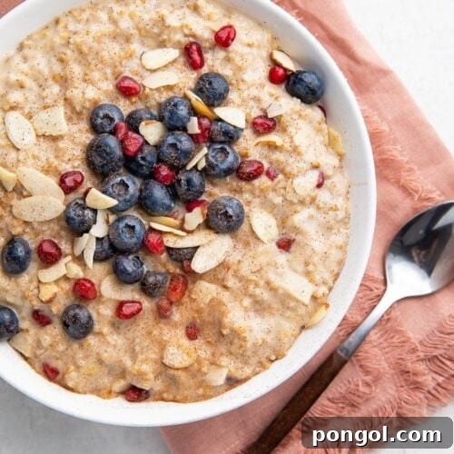 Bowl of steel cut oats with a pink napkin and spoon
