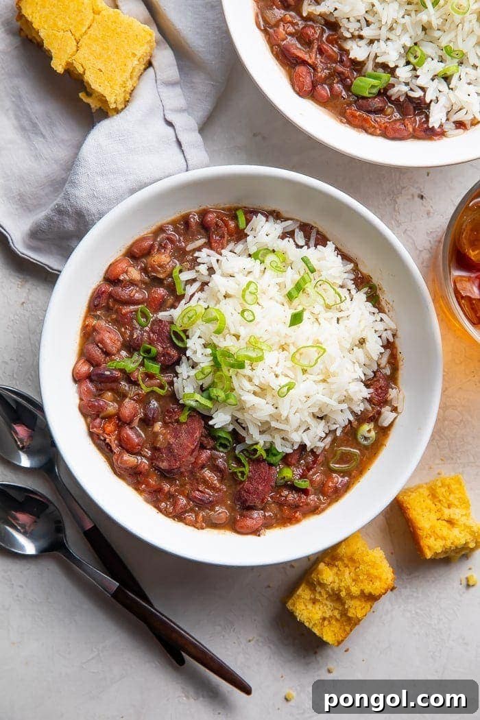 Delicious Instant Pot Red Beans and Rice in a bowl, served with a side of golden cornbread.