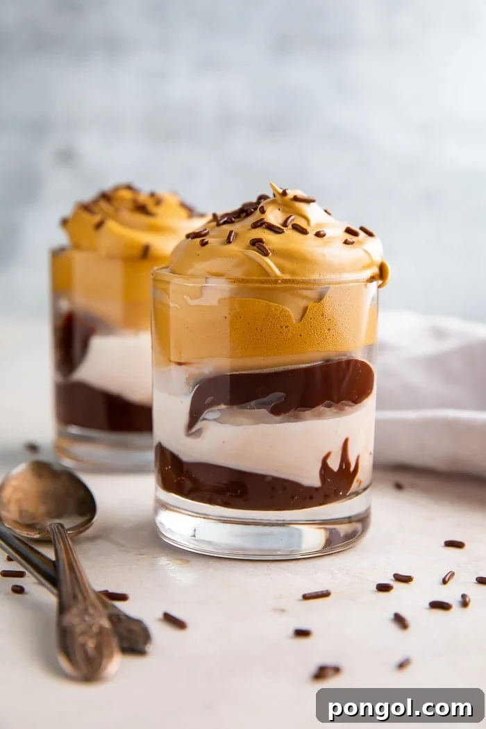 Multiple glasses of whipped coffee ice cream sundaes artfully arranged for serving.