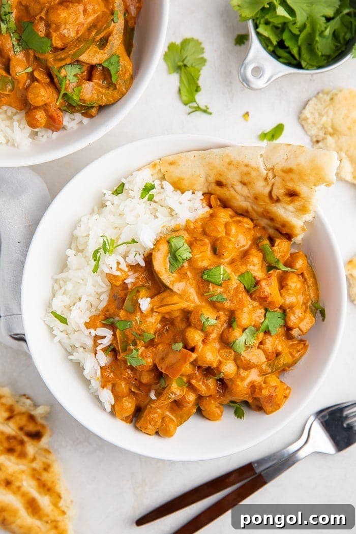 Bowls of chickpea tikka masala with naan
