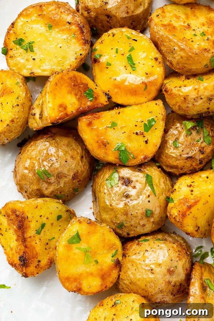 Close-up of golden brown, crispy air fryer potatoes with a soft focus background.