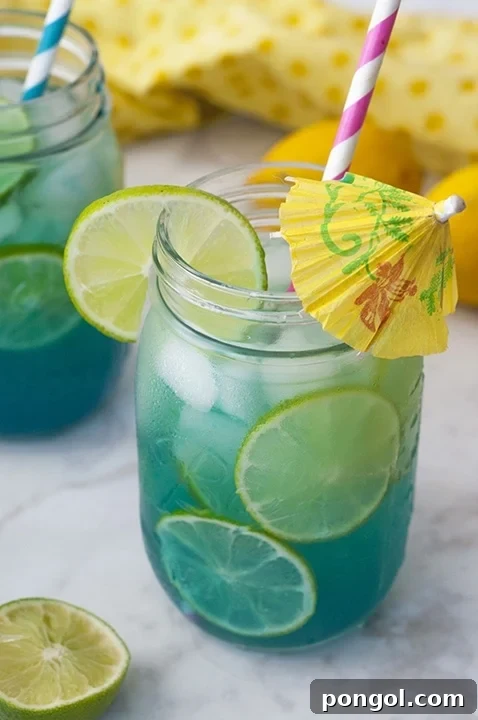 A glass of vibrant pink Watermelon Moscato Slush, with a smooth, icy texture, garnished with a small, inviting watermelon slice.