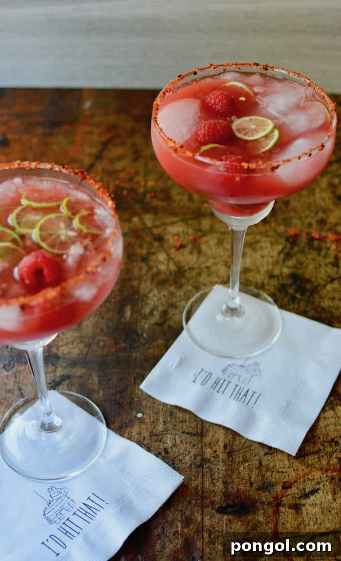A large, inviting punch bowl generously filled with Moscow Mule Punch, elegantly garnished with vibrant lime wedges and fresh mint sprigs.