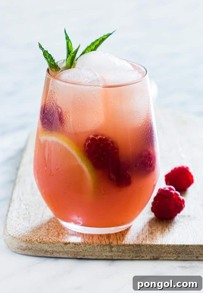 A elegant pitcher filled with vibrant Prosecco Margaritas, accompanied by glasses and garnished with fresh lime wedges, ready for serving.