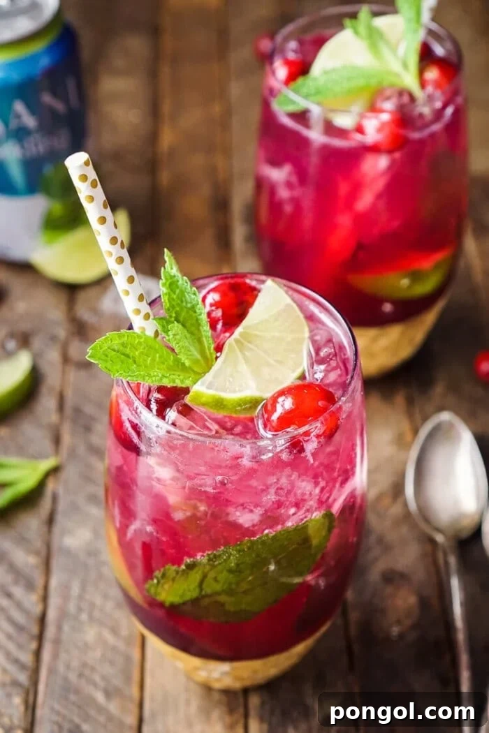 Several glasses brimming with deep red Cherry Margaritas, elegantly garnished with fresh cherries, ready to be enjoyed.