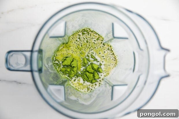 Ingredients for iced matcha latte in a blender