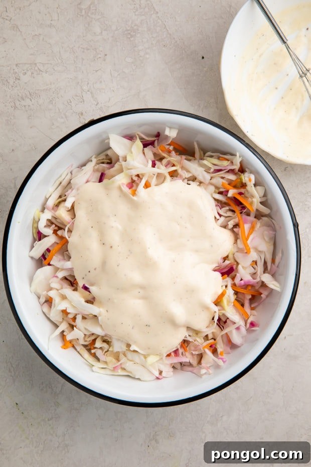 Whisking together the keto coleslaw dressing ingredients.