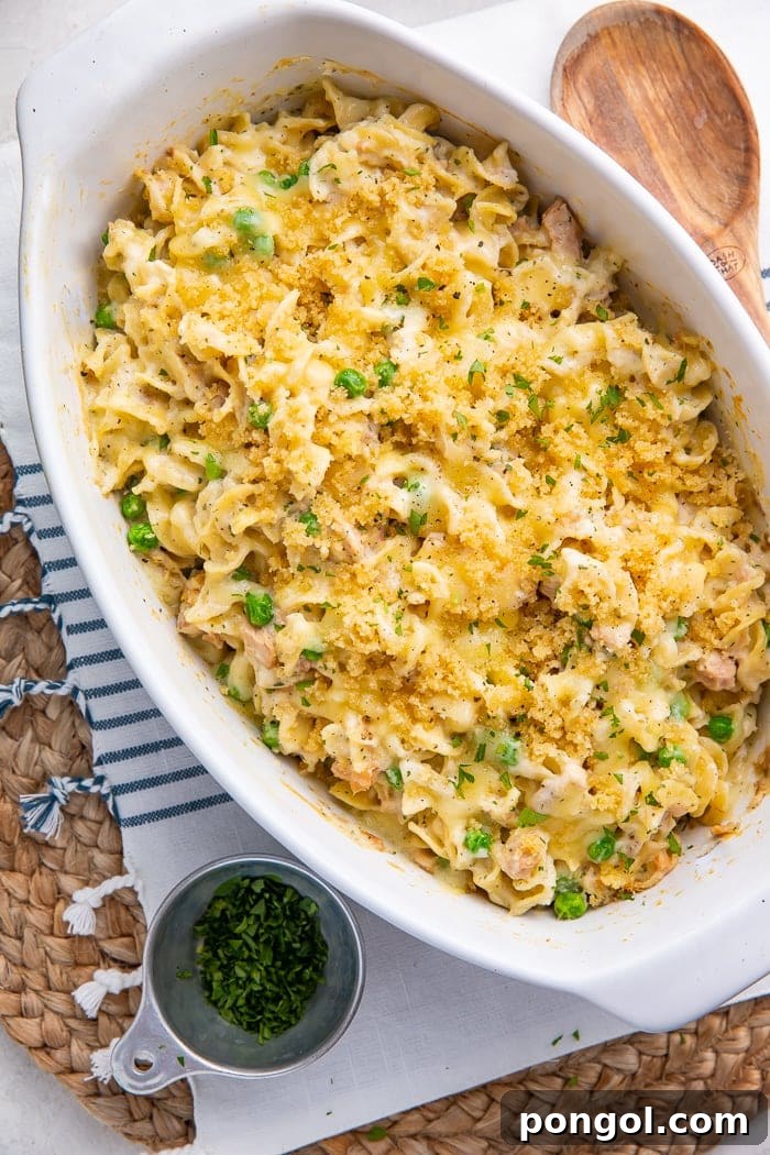 Classic Tuna Noodle Casserole in a baking dish, creamy with peas and breadcrumb topping.