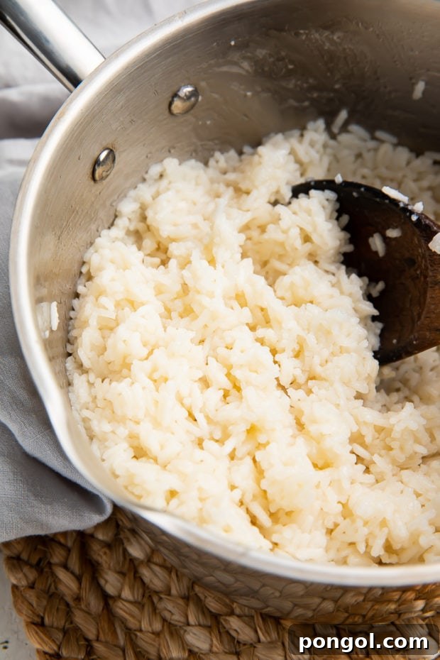 Coconut rice simmering on the stovetop