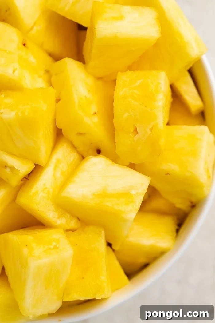 Unlock the Secret to Easy Pineapple Slicing 2 Close-up of chunks of pineapple in a bowl, showcasing perfectly cut pieces
