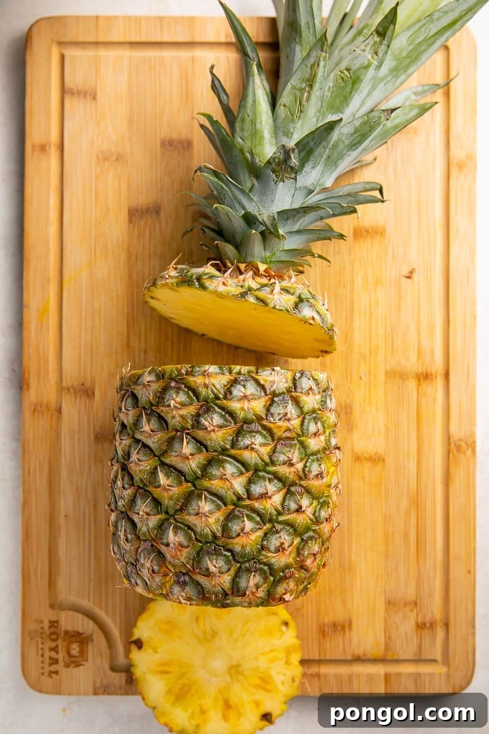 Unlock the Secret to Easy Pineapple Slicing 3 Pineapple with top and bottom removed, ready for peeling