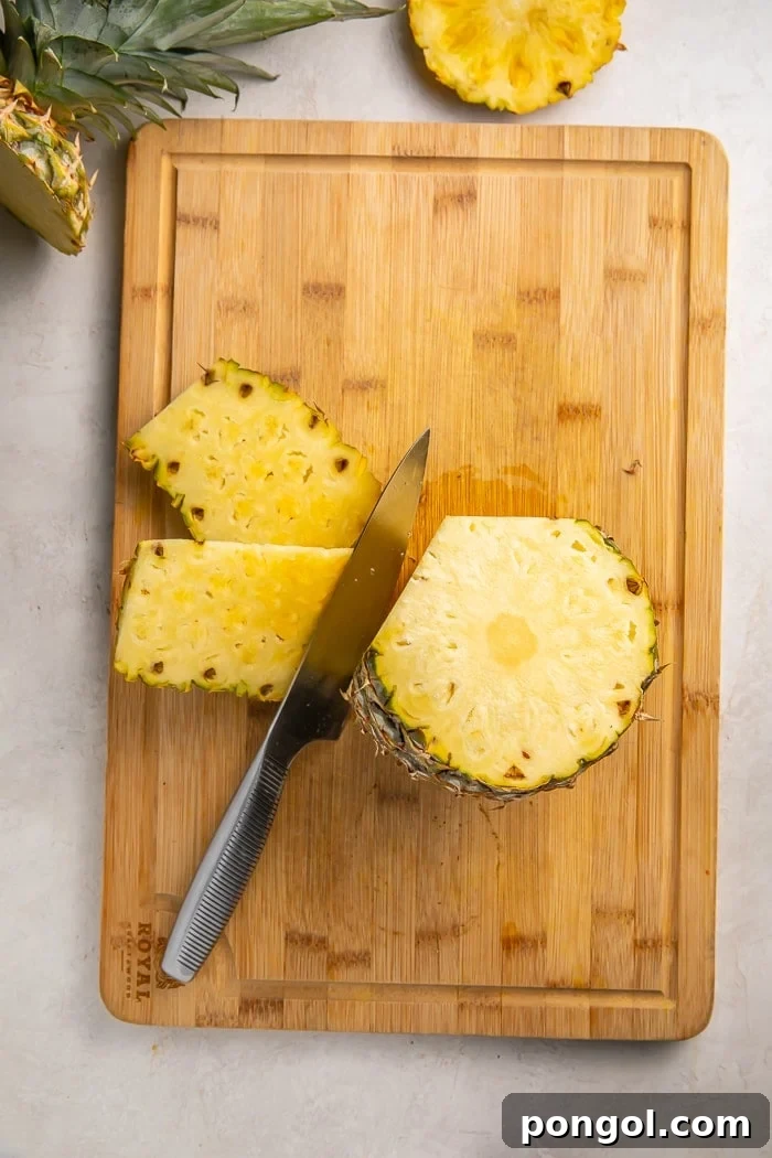 Unlock the Secret to Easy Pineapple Slicing 4 Cutting the skin off a pineapple in vertical strips