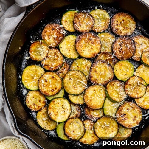 Crispy sauteed zucchini discs topped with finely shredded cheese.