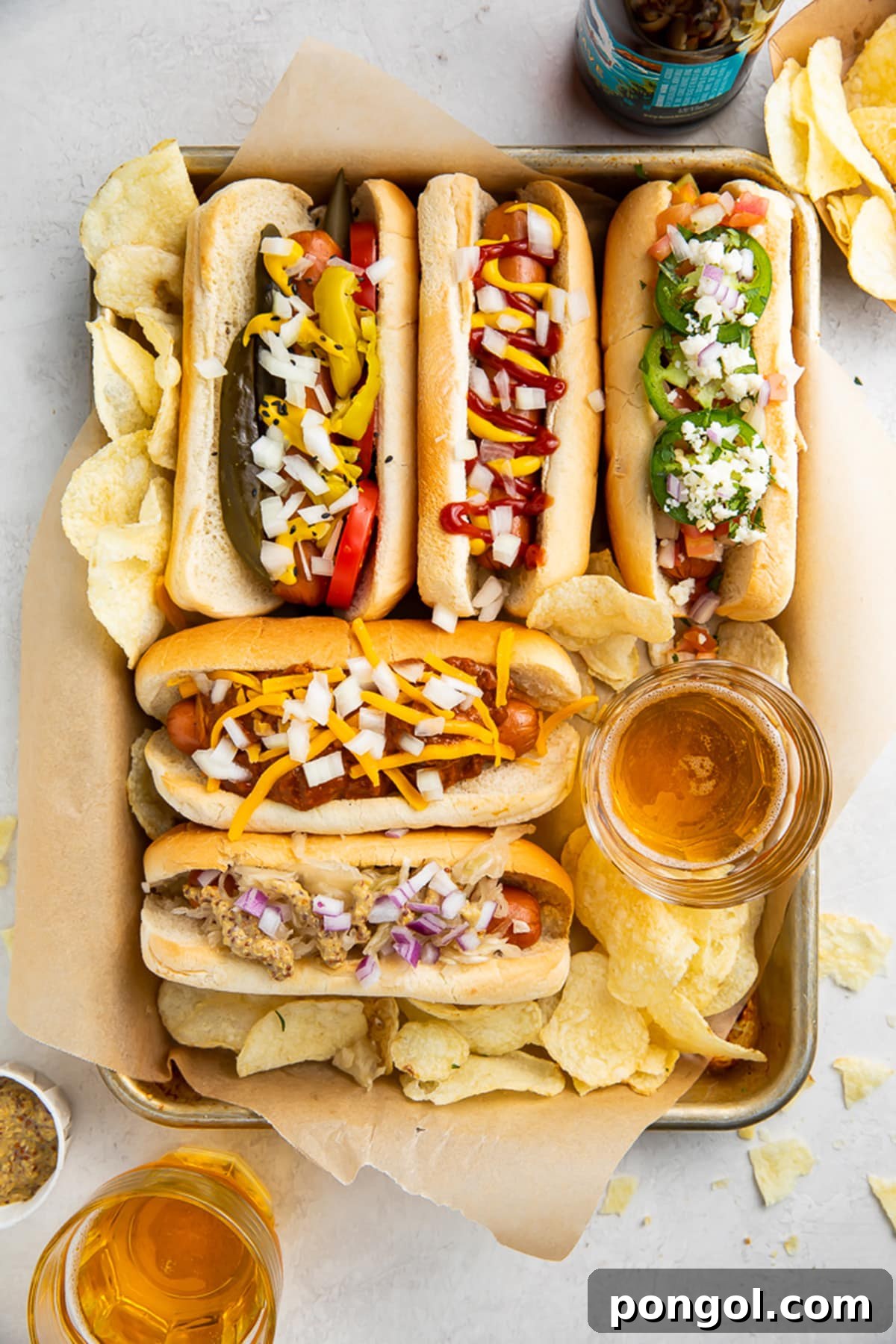 Crispy Air Fryer Hot Dogs 2 Five perfectly cooked air fryer hot dogs in golden, toasted buns, artfully arranged on a baking sheet with an assortment of vibrant toppings.