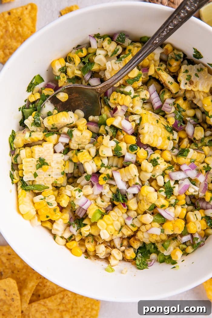 Freshly made corn salsa served in a ceramic bowl, ready for dipping.