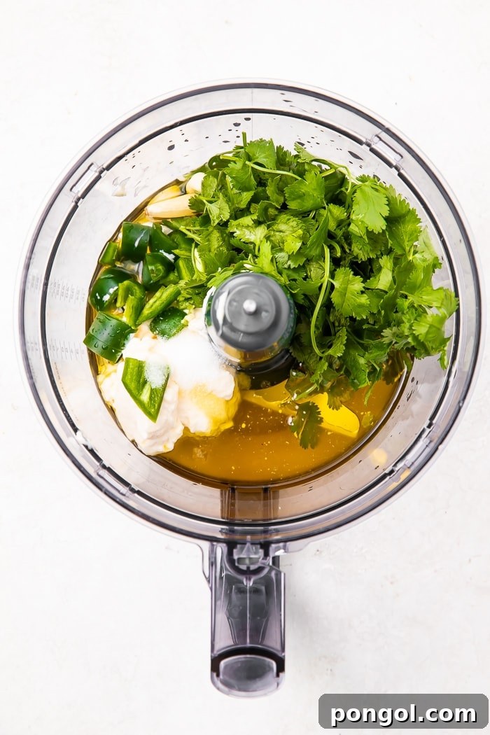 A close-up shot of a small bowl filled with the freshly prepared, creamy cilantro lime dressing, showing its smooth texture.