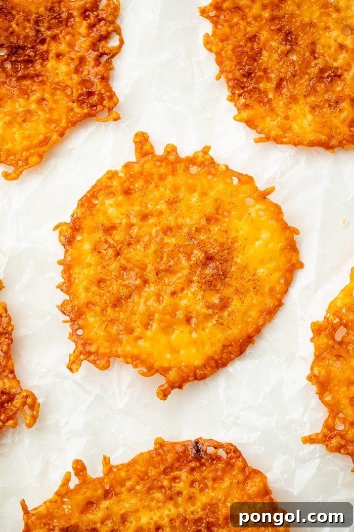 Cheesy Keto Crisps 2 Crispy Keto Cheese Chips on Parchment Paper