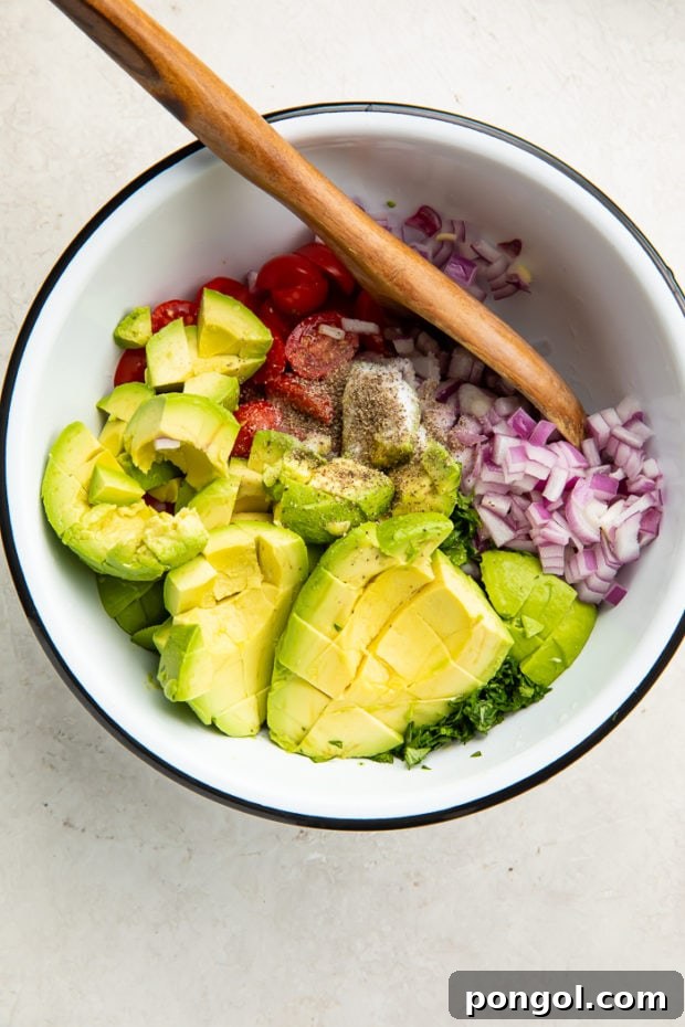 Mixing avocado salad ingredients